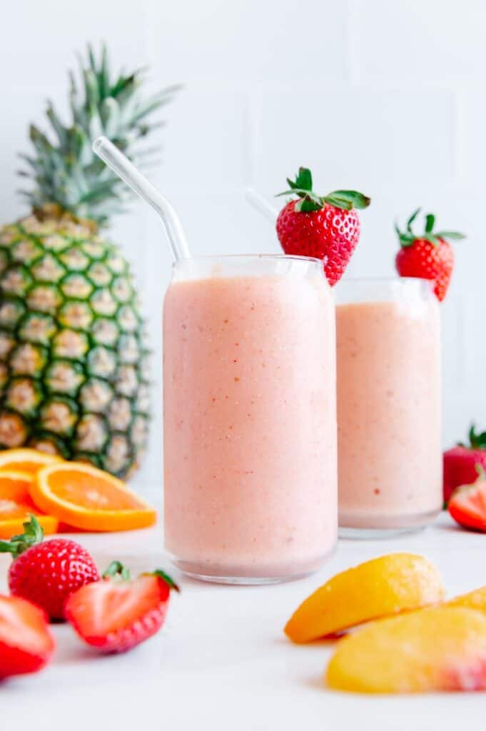 A vegan pineapple, mango, strawberry, and peach smoothie.