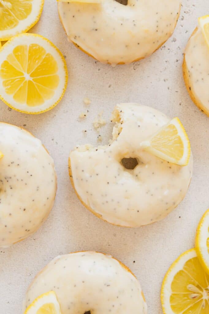 Overhead photo of a bunch of lemon poppy seed donuts.