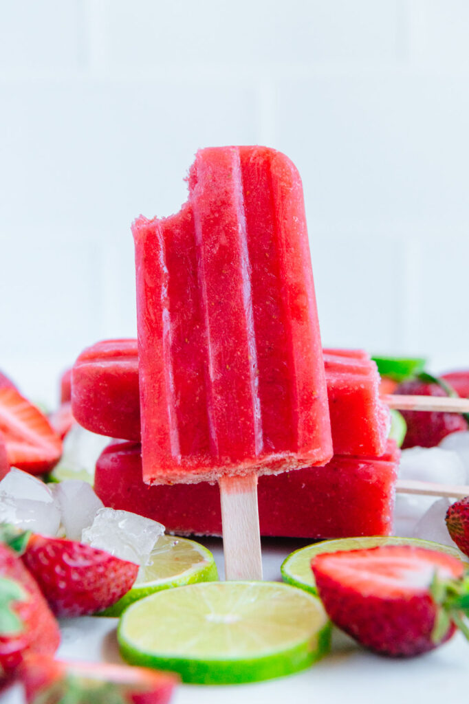 A strawberry popsicle with lime juice and zest in it.