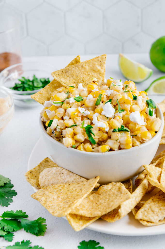 Mexican street corn dip with tortilla chips.