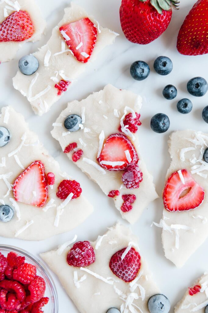 Pieces of frozen yogurt bark with berries.