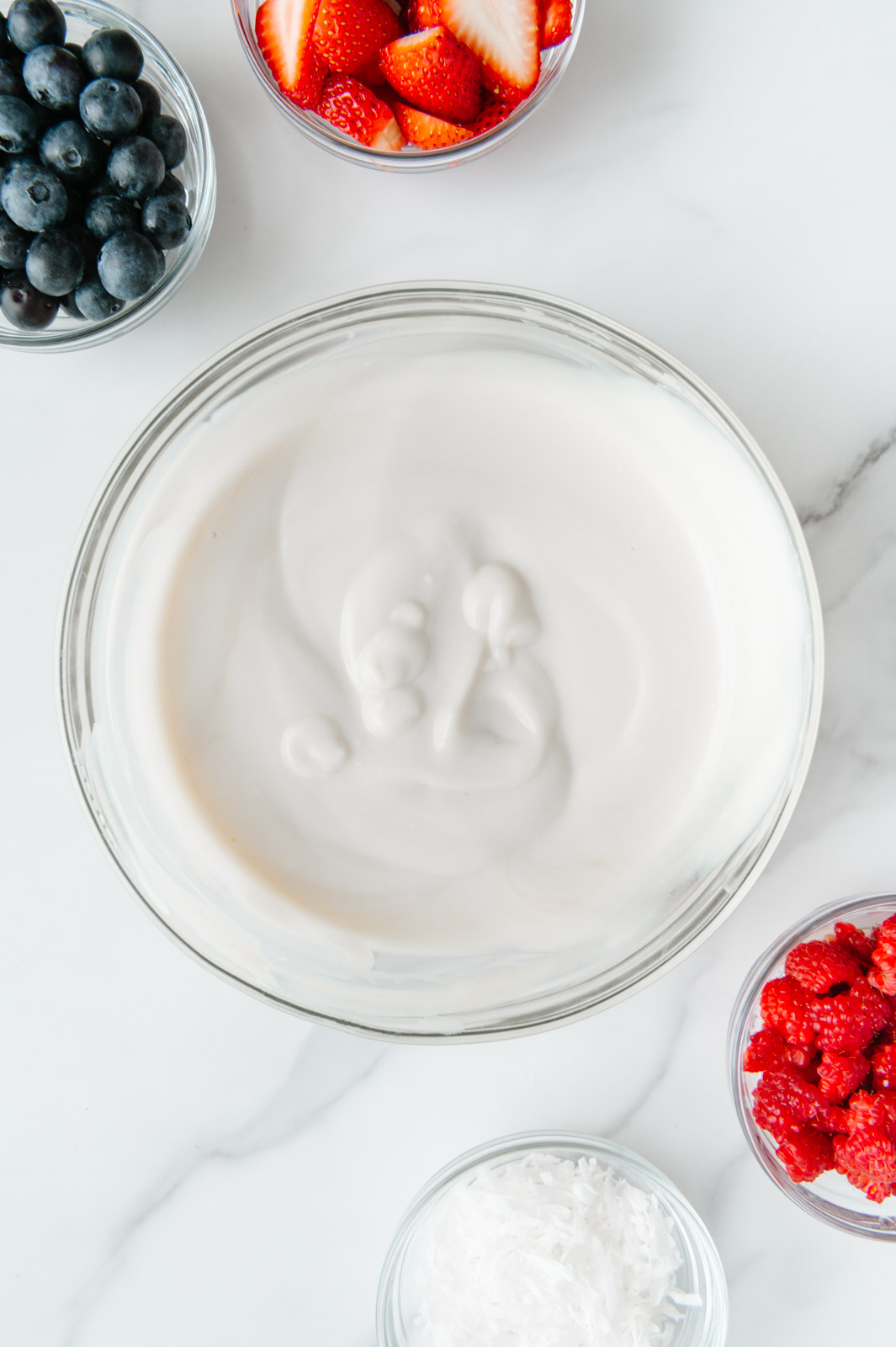 Dairy-free yogurt mixed with vanilla extract and maple syrup.