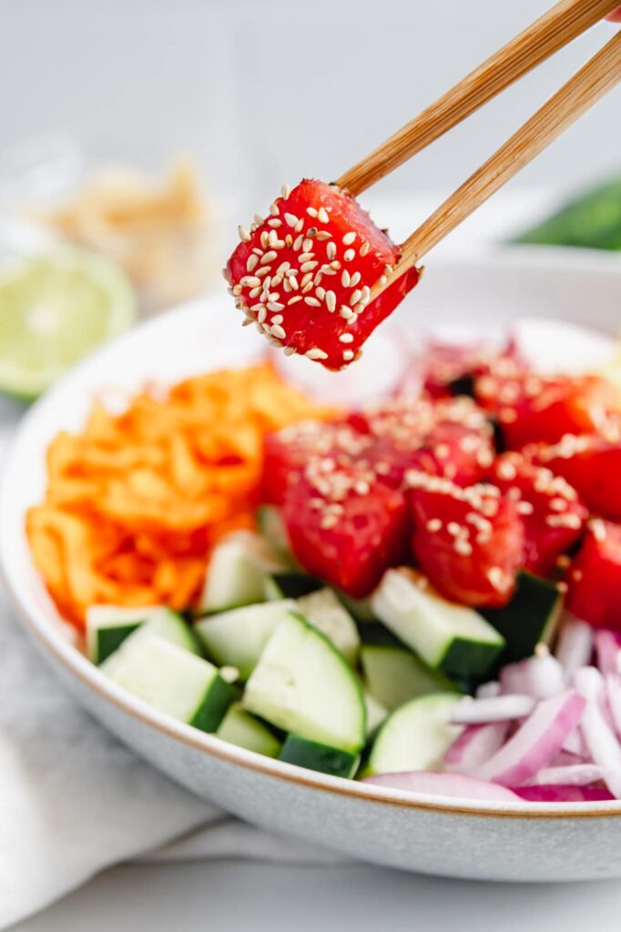Chop sticks with a piece of fish-free watermelon "tuna."
