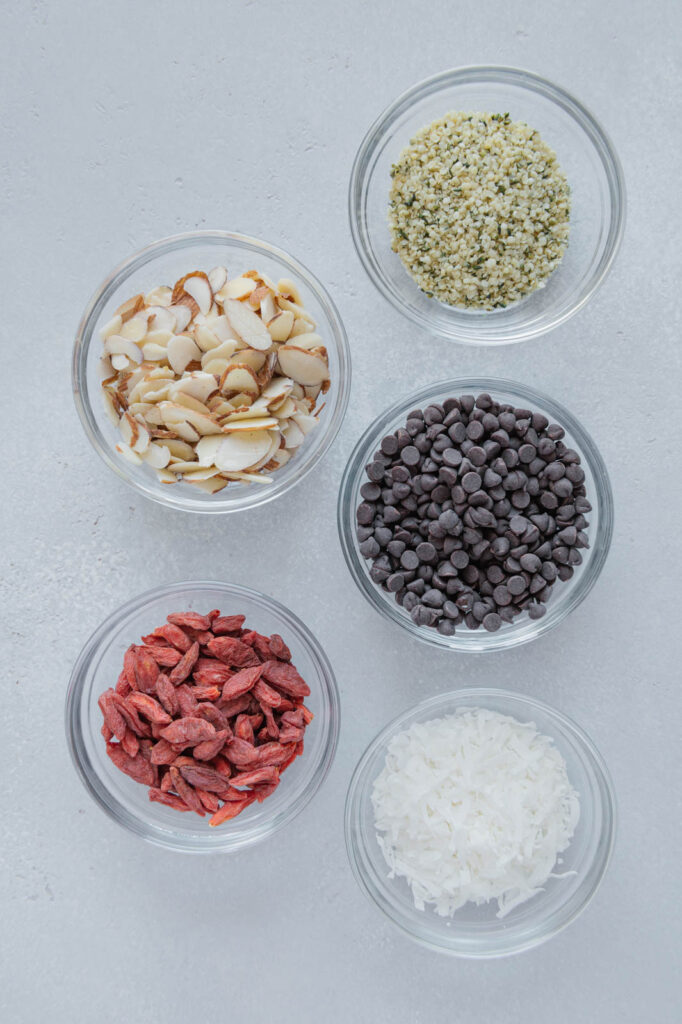 Add-in ingredients for granola bars in glass bowls.