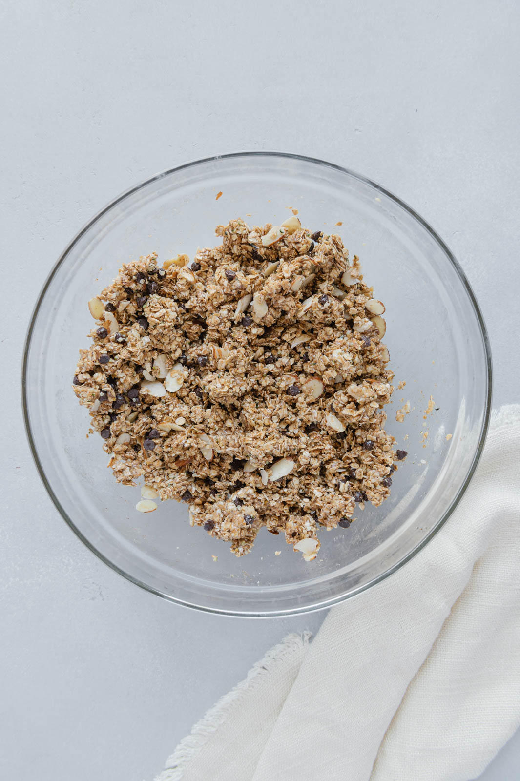 No-bake granola bars mixture in a large glass mixing bowl.