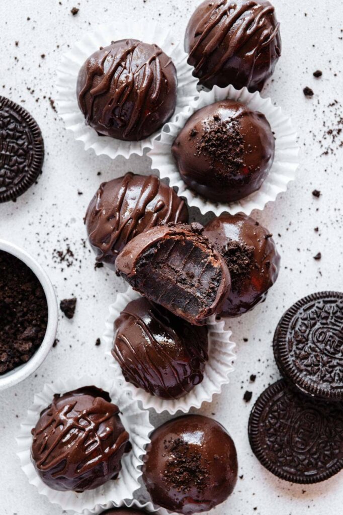 Oreo truffles in mini muffin liners stacked close to one another.