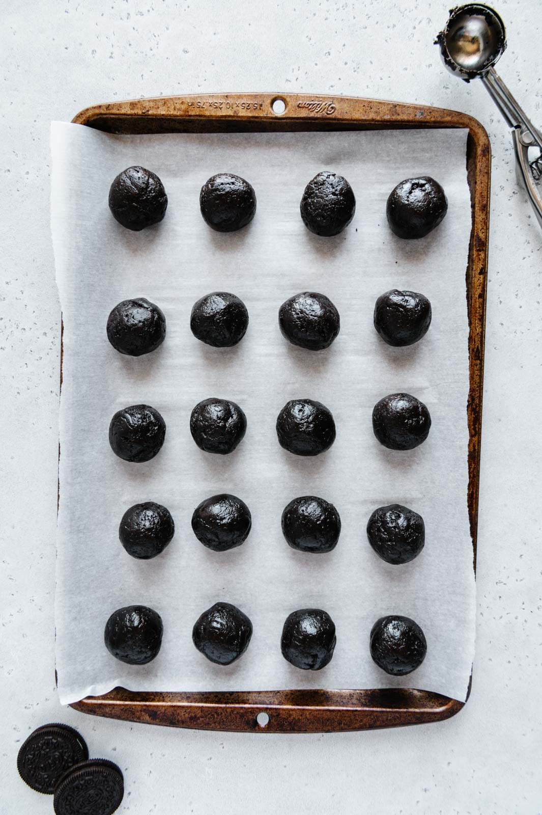 Oreo truffles rolled into balls on a baking tray.