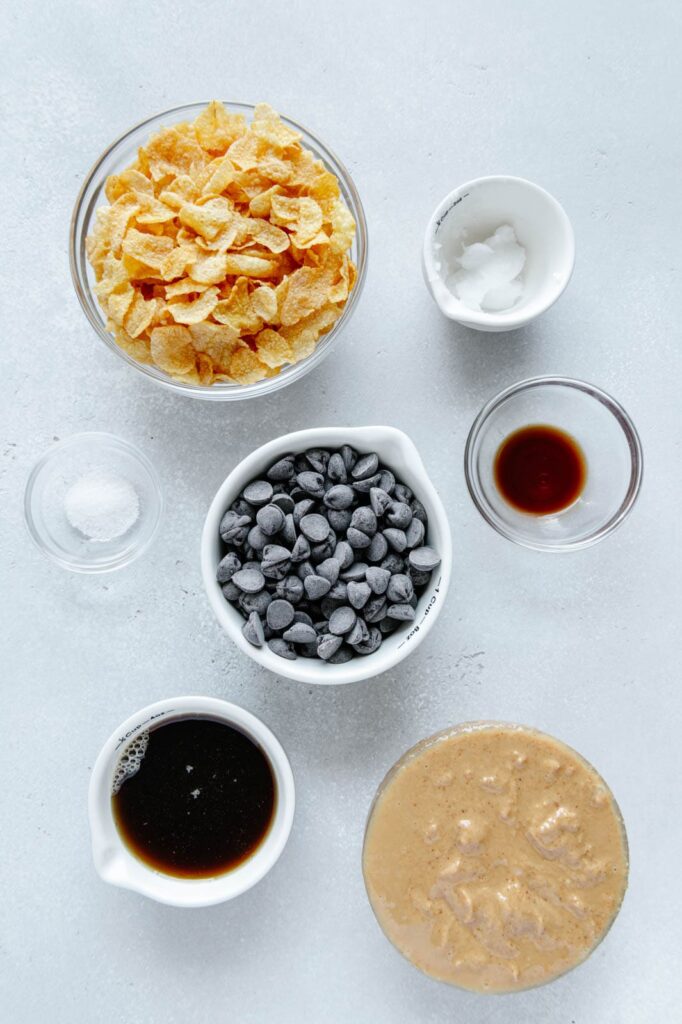 Ingredients to make vegan cornflakes in glass bowls.