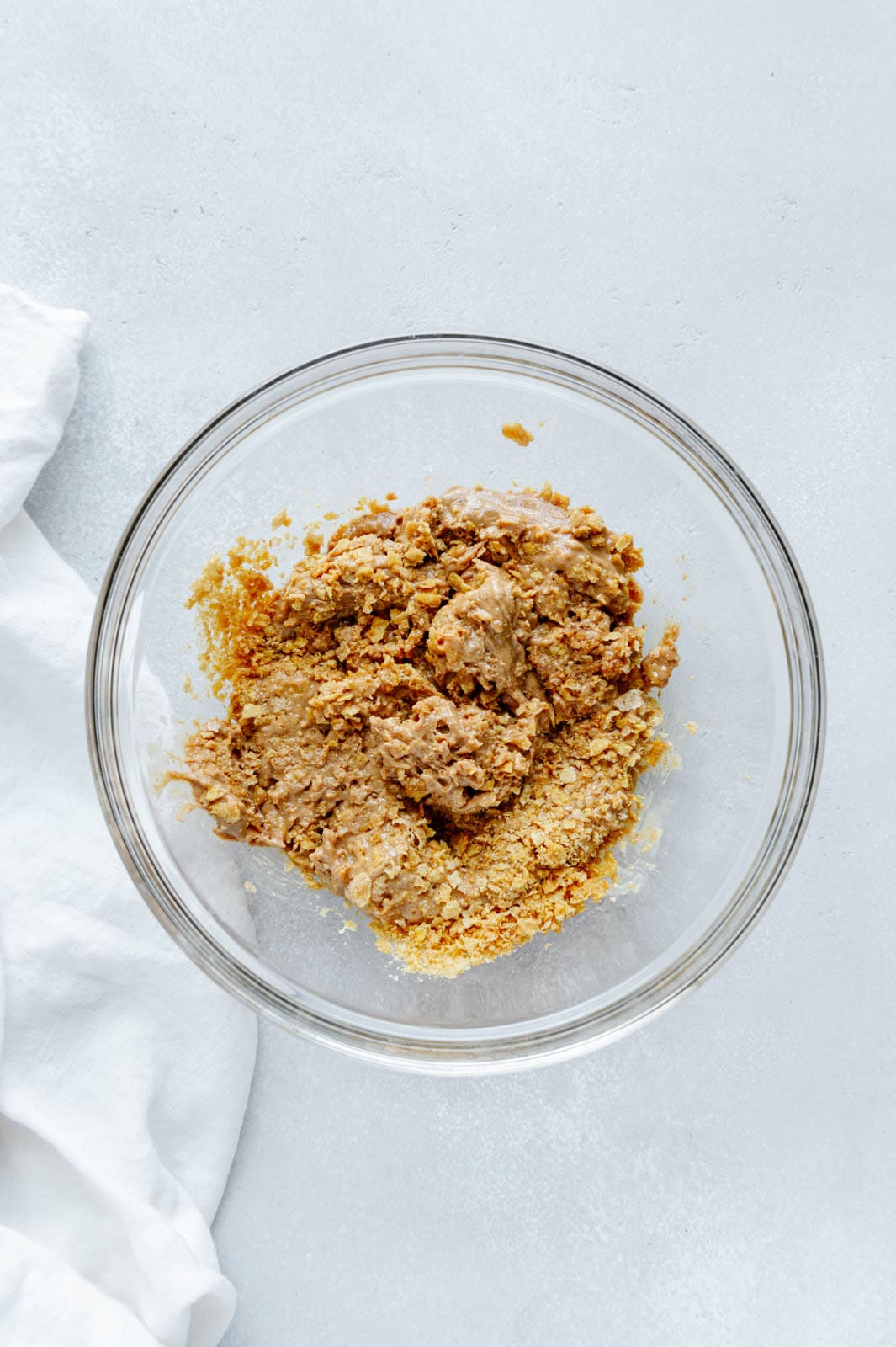 Peanut butter, cornflakes, vanilla extract, and salt in a mixing bowl.