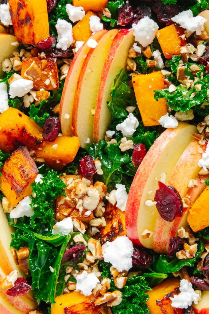 Upclose of all of the textures, colors, and ingredients of a fall harvest salad.