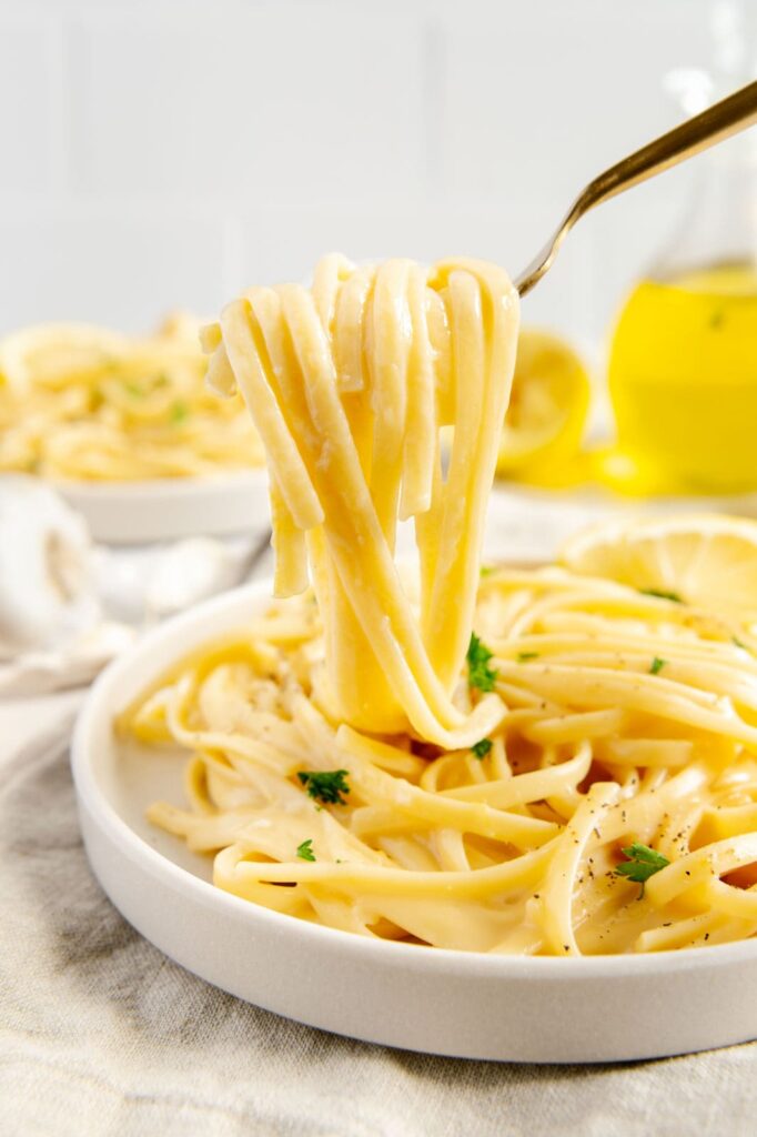 A fork full of vegan pasta al limone.