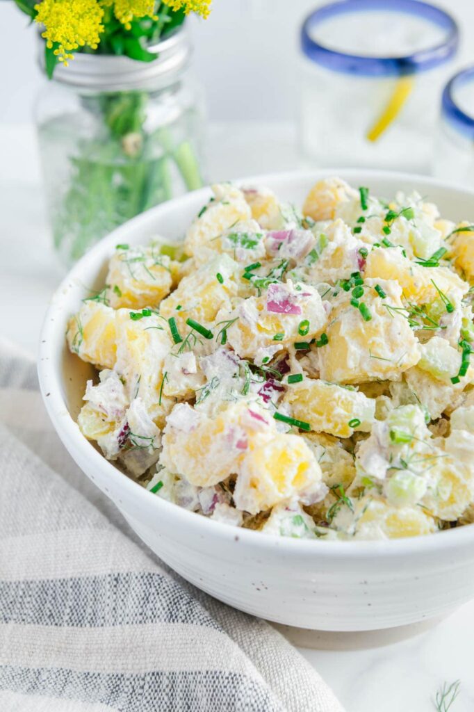 A bowl of vegan potato salad with dill.