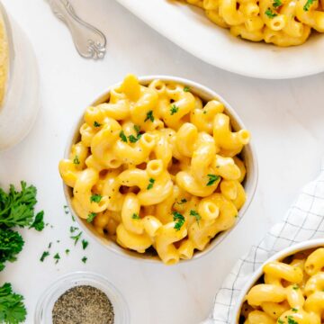 Several bowls of cheesy vegan mac and cheese.