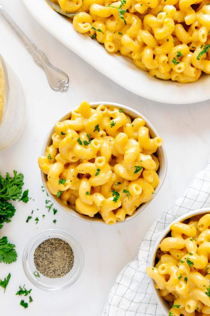 Several bowls of cheesy vegan mac and cheese.