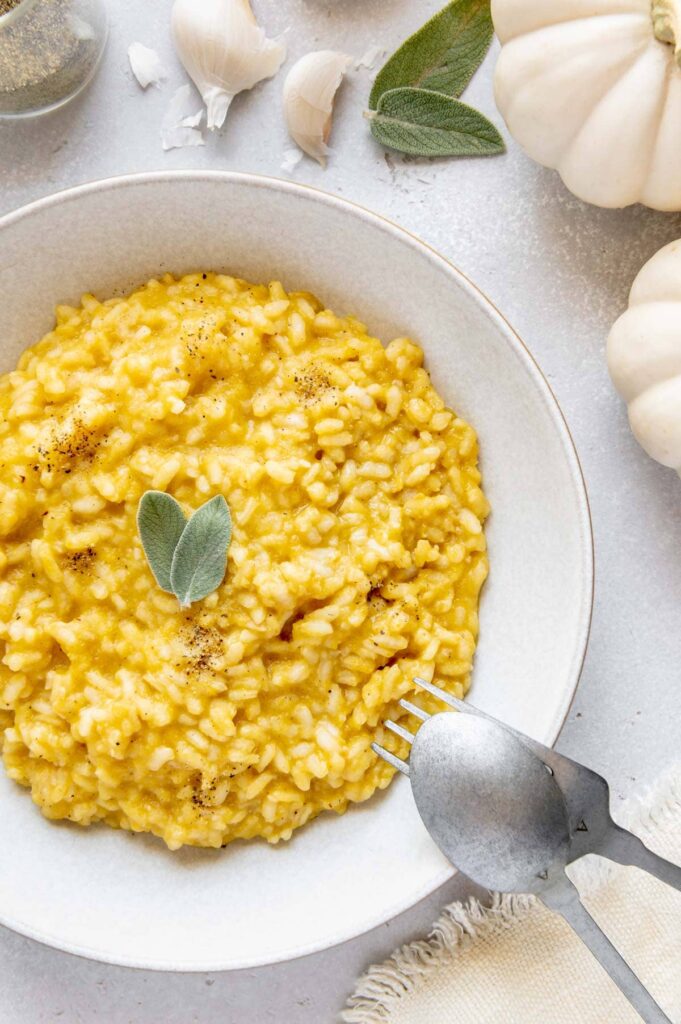 Pumpkin risotto with a fork and spoon.
