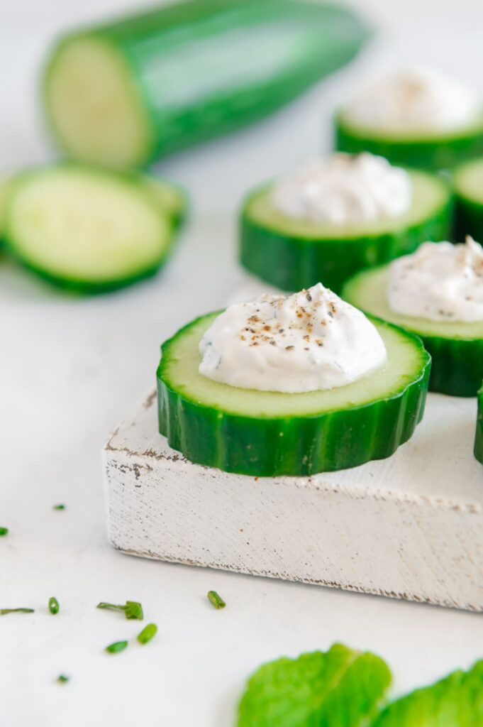 Upclose of a cucumber bite on a platter.