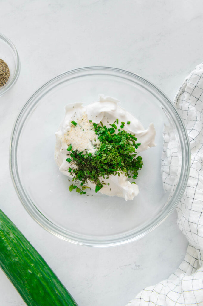 Ingredients to make creamy and herby topping for cucumber bites.