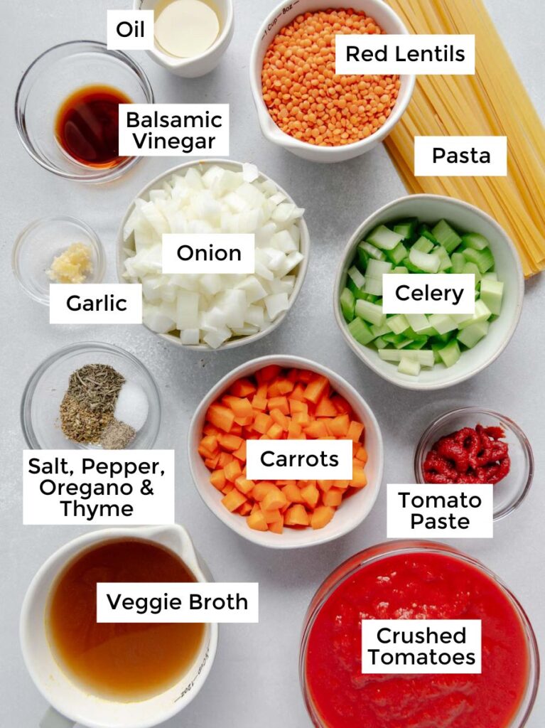 Labeled ingredients in bowls used to make red lentil bolognese sauce.