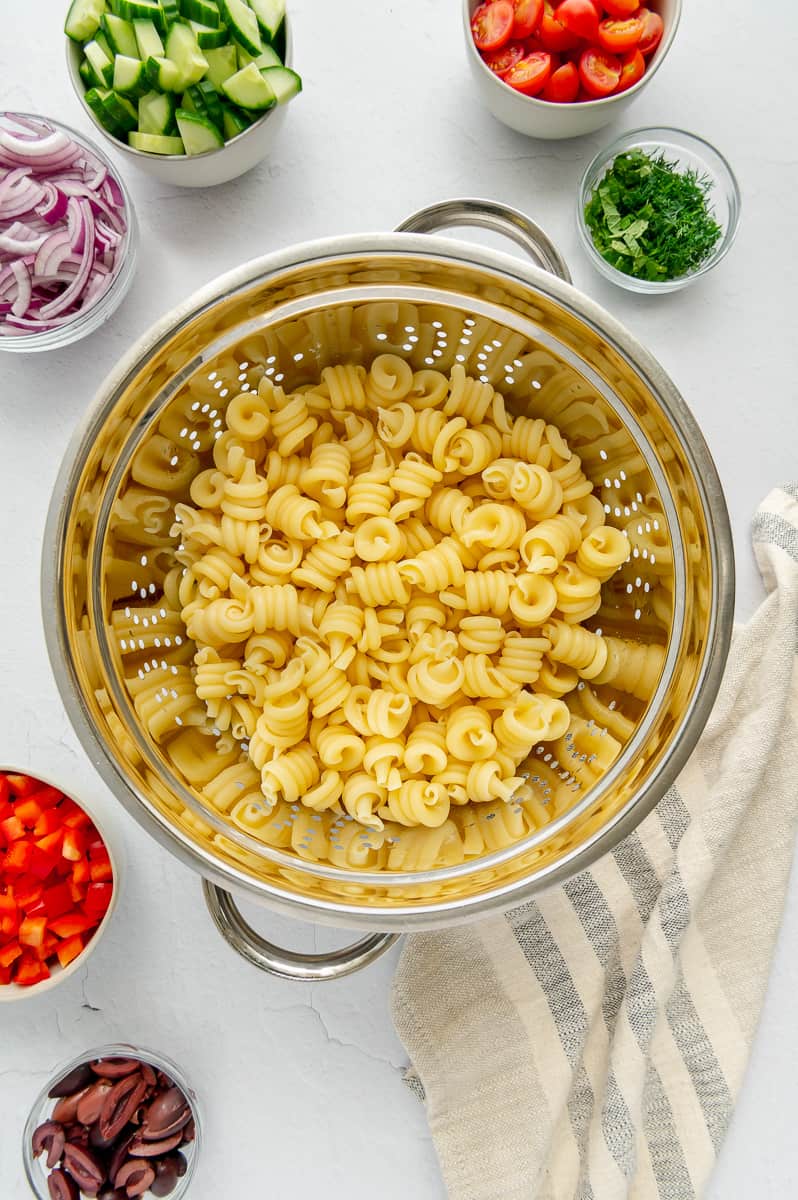 Cook short-cut pasta draining in a colander.