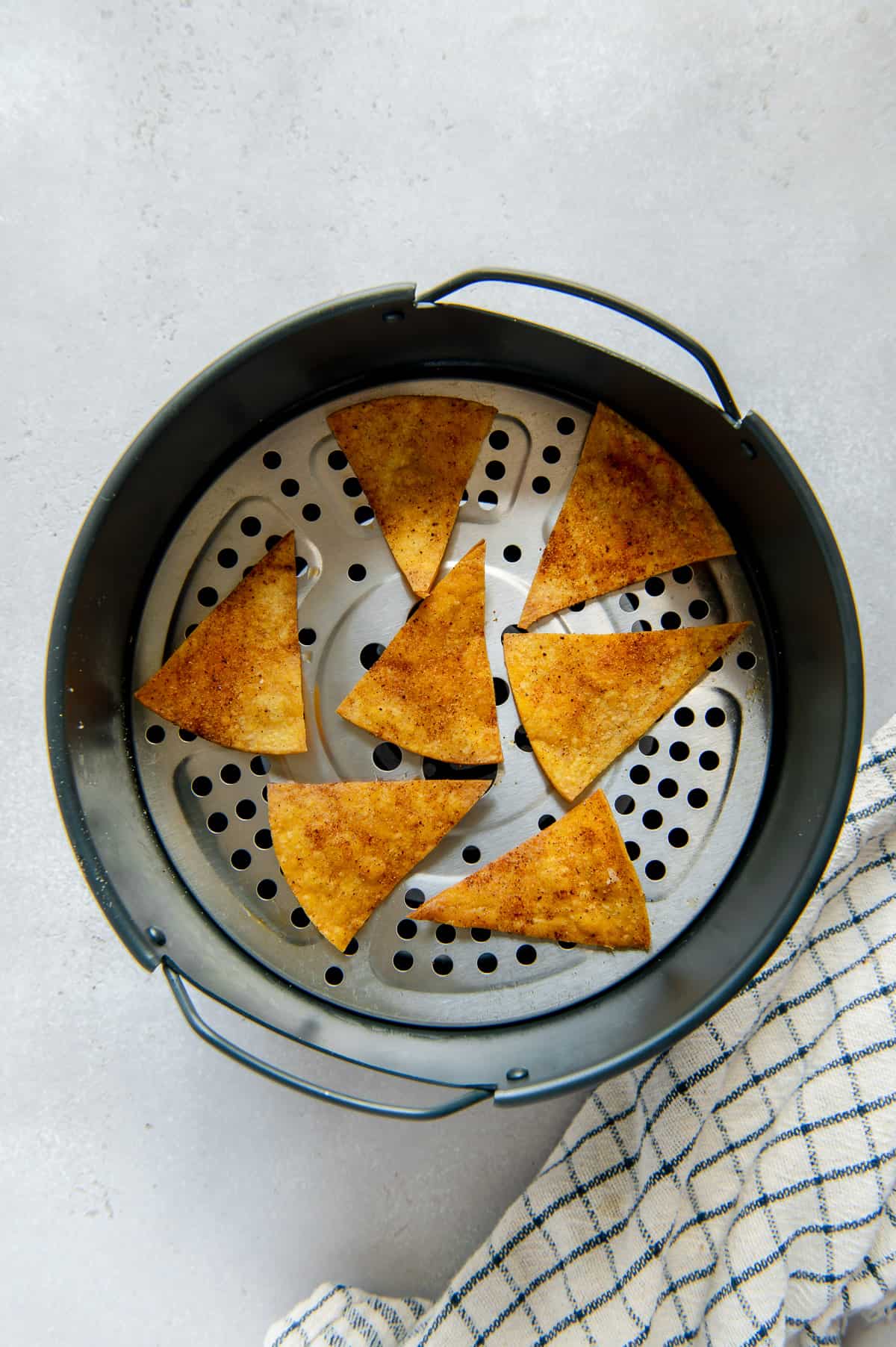 Crispy tortilla chips after cooking in an air fryer.