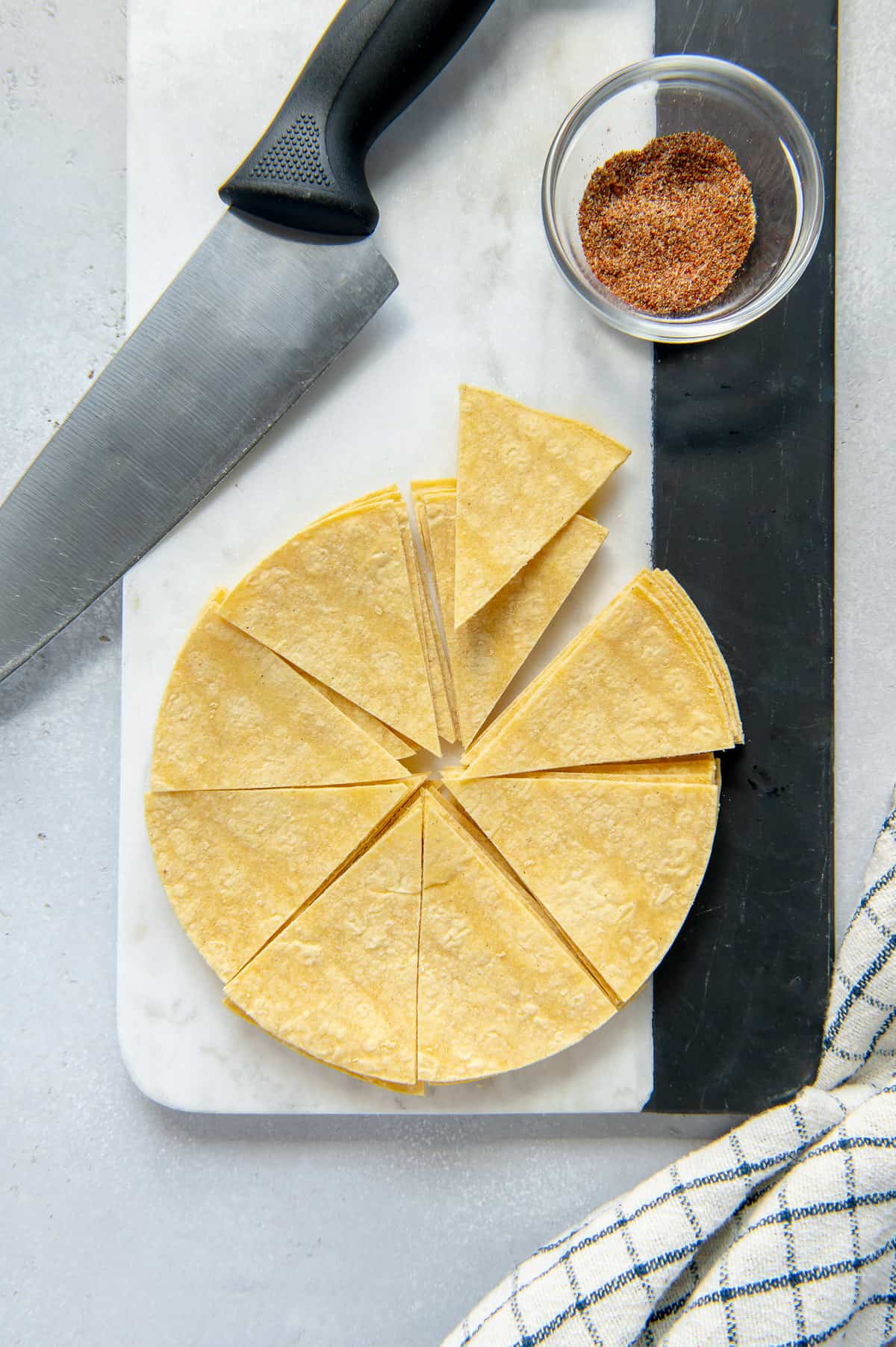 Corn tortillas cut into wedges to be made into chips.