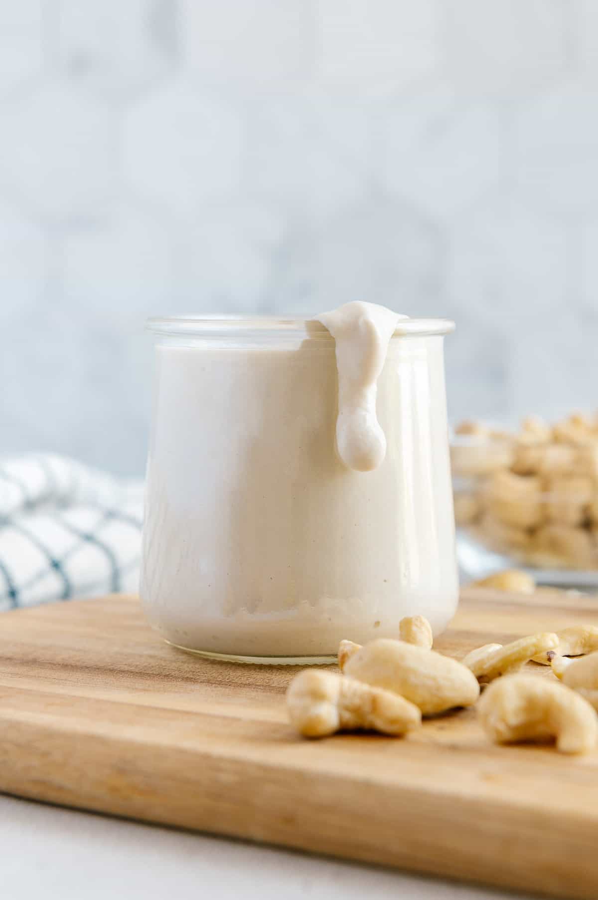 Simple homemade cashew cream in a glass jar for storage.