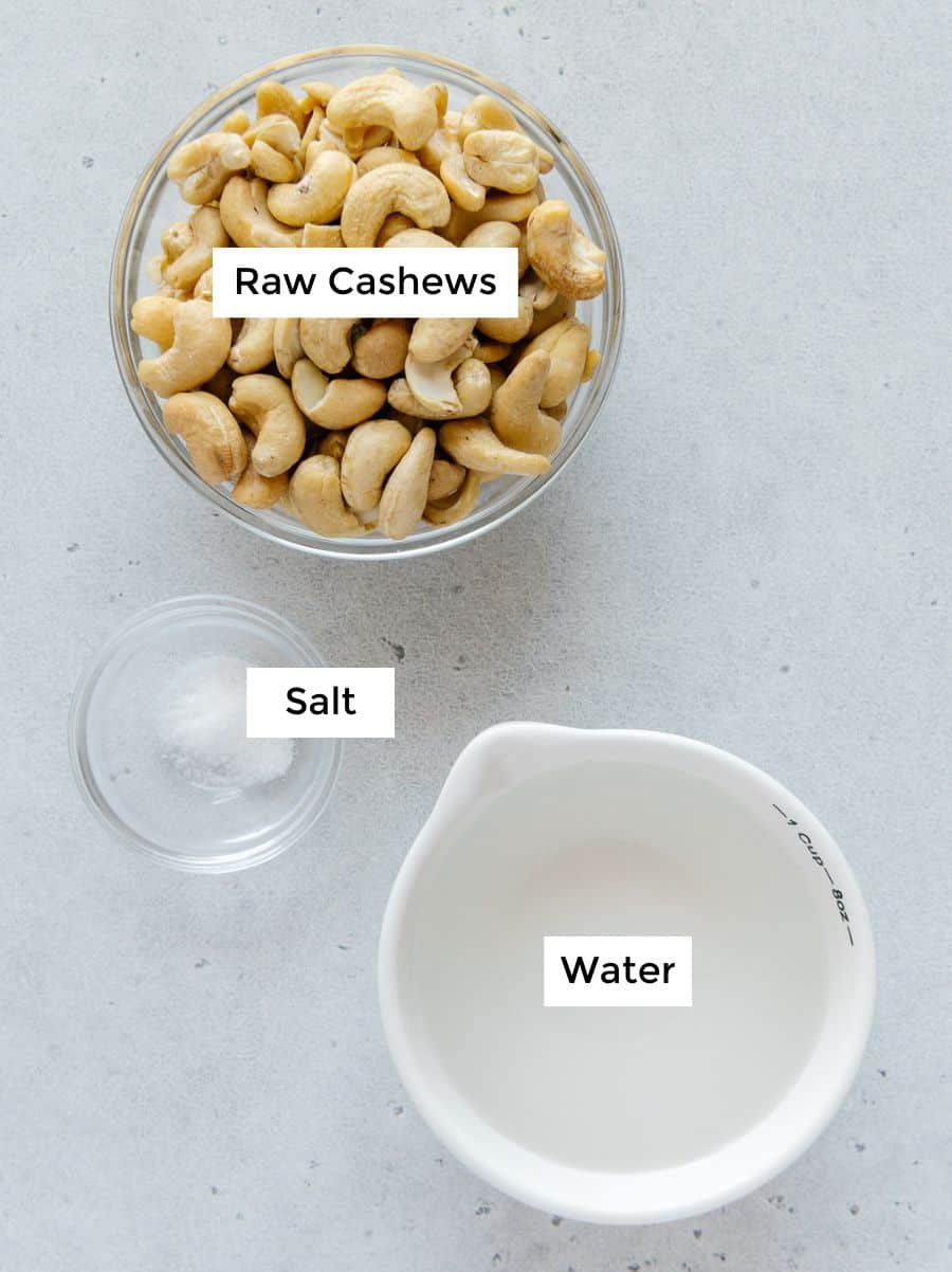 Cashews, water and salt in bowls to make plant-based cashew cream.